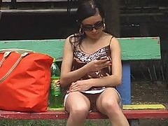 Hidden upskirt video of hot teen girl flashing her fat lipped pussy on the bench voyeur video #1