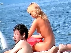 Charming slim blond with small sexy tits was tanning naked on the beach voyeur video #2