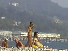 Young and pretty teen babe is ready to lie on the beach sand voyeur video #3