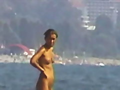 Young and pretty teen babe is ready to lie on the beach sand voyeur video #4